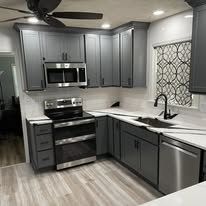 Contemporary kitchen with gray cabinetry and tile backsplash