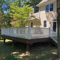 Custom-built backyard deck with white railings