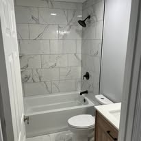 Marble-tiled bathtub and shower surround